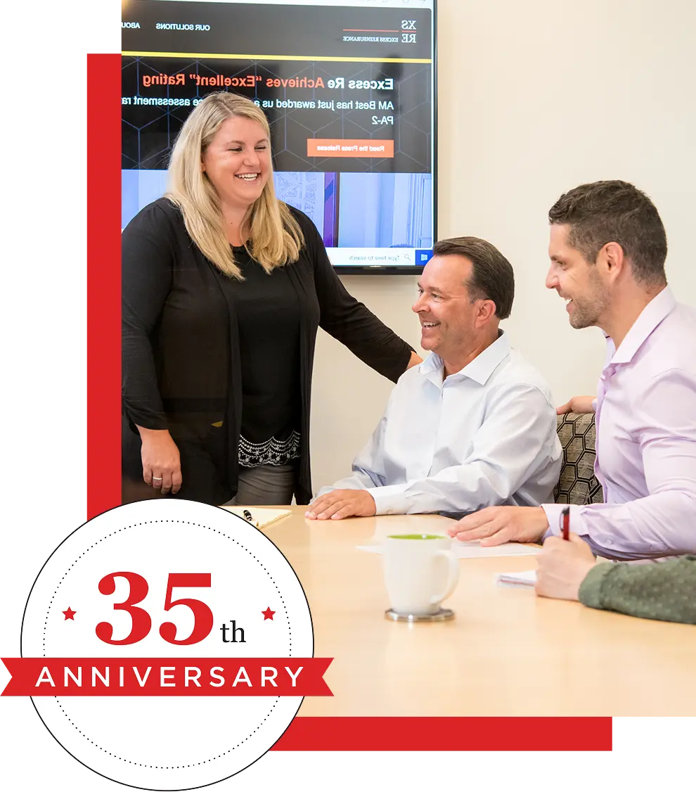 Coworkers laughing in meeting - 35th Anniversary